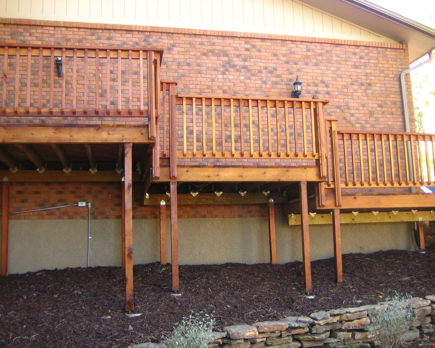 A multi-level redwood deck with a snow fence style railing. Built in Colorado Springs by Decks by Schmillen.