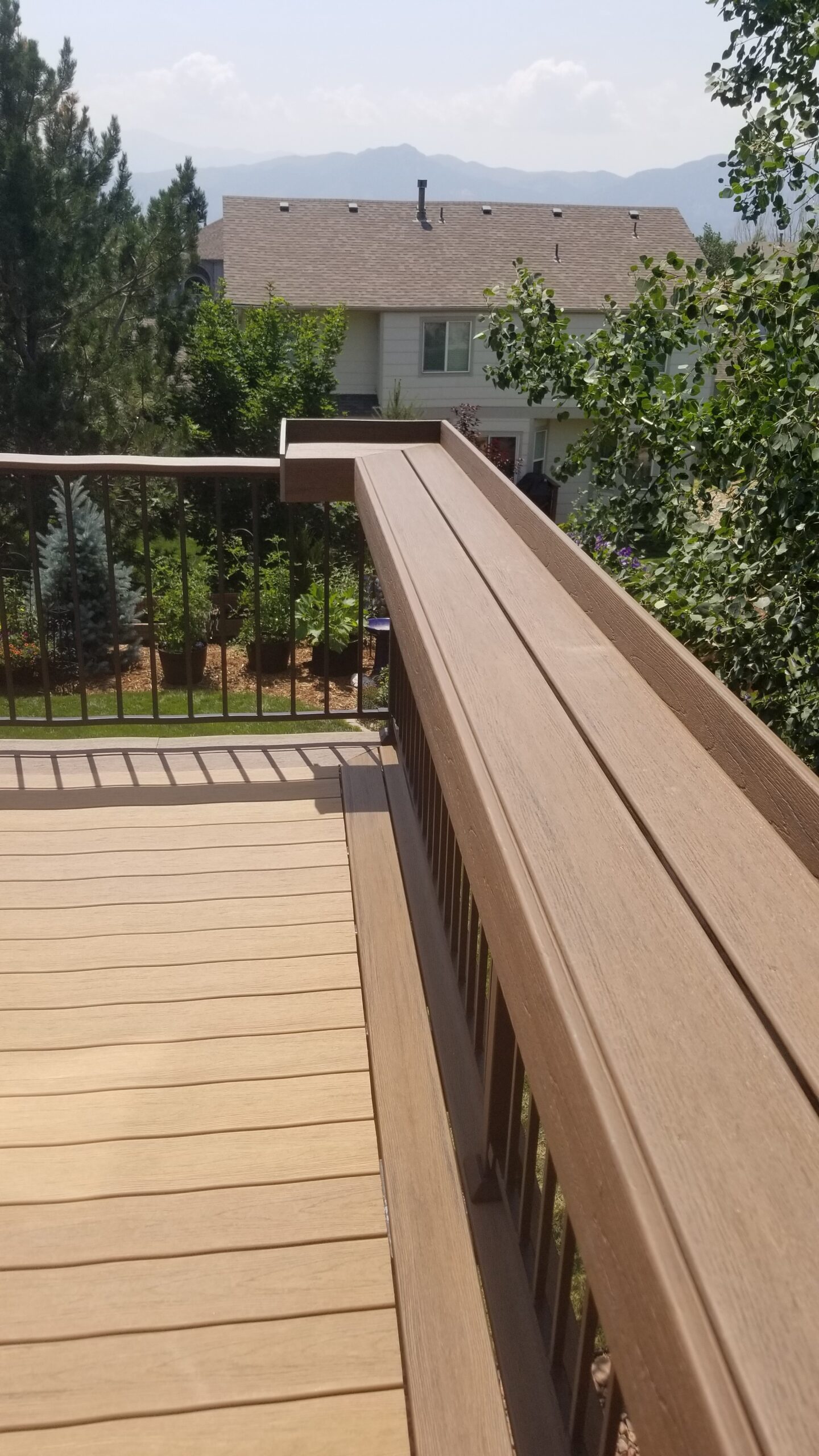 Custom designed and built dining rail, it is built on top of the deck railing