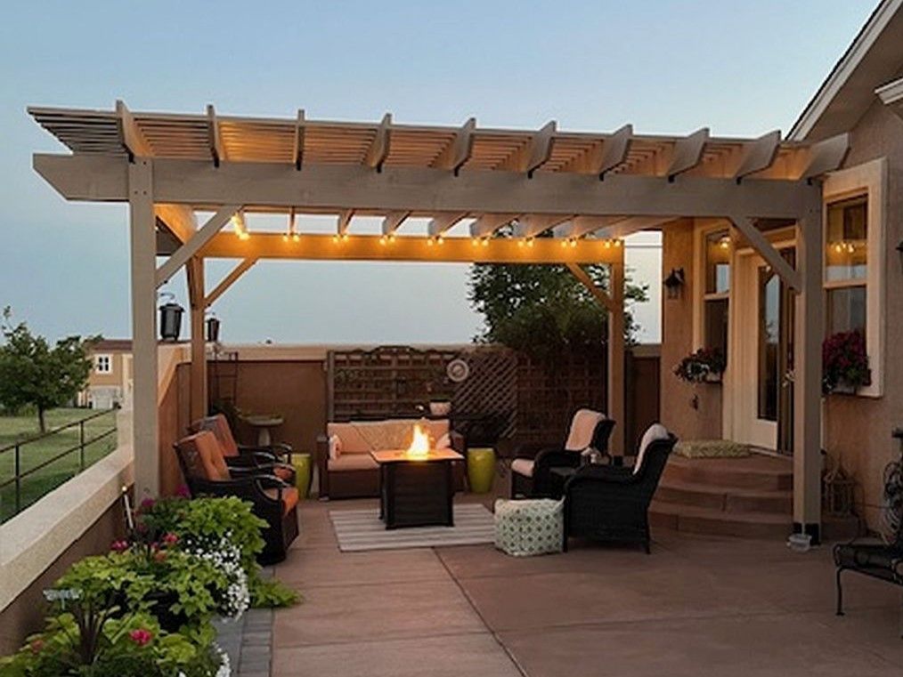 Outdoor living area on stamped concrete patio with cedar pergola and fire pit in Colorado Springs