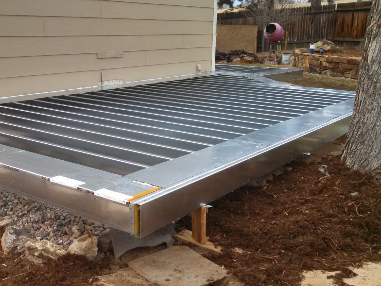 Ground level composite deck being built with Cemco galvanized steel deck framing