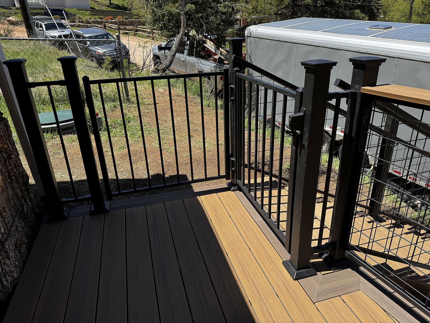 Custom built composite deck in Green Mountain Falls Colorado built with Deckorators Voyage Sedona for the main decking and a double-board picture frame in Deckorators Voyage Khaya