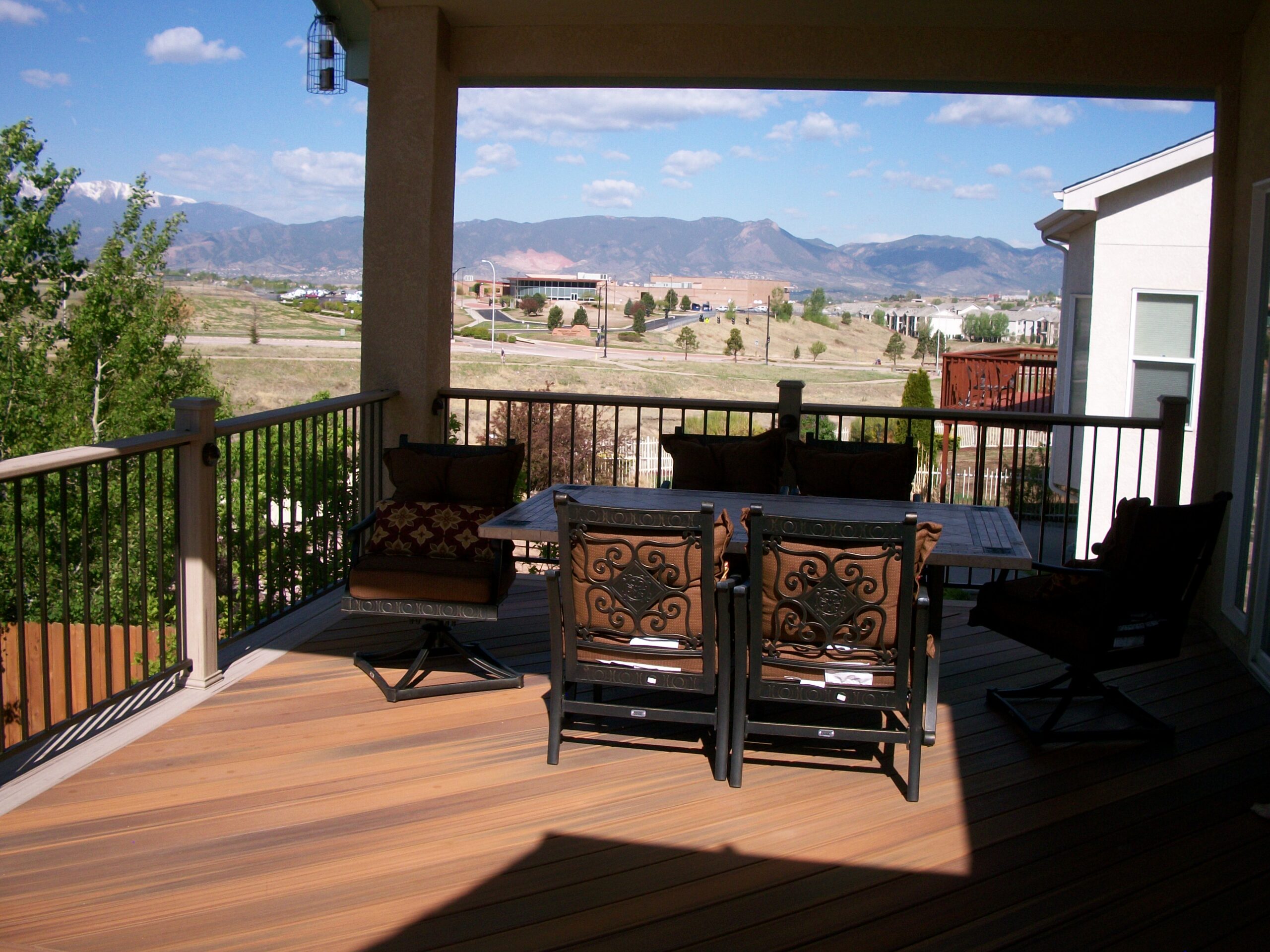 Composite deck with gabled deck cover in northeast Colorado Springs creates an outdoor living space with amazing view of the mountains