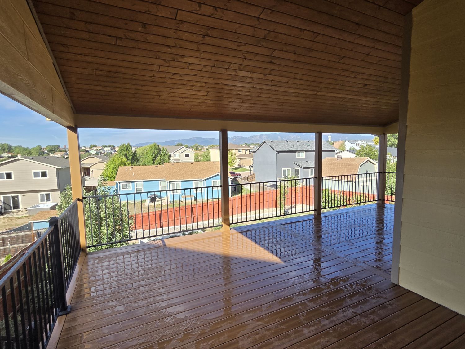 Custom outdoor living space in Colorado Springs with Deckorators composite deck and deck cover