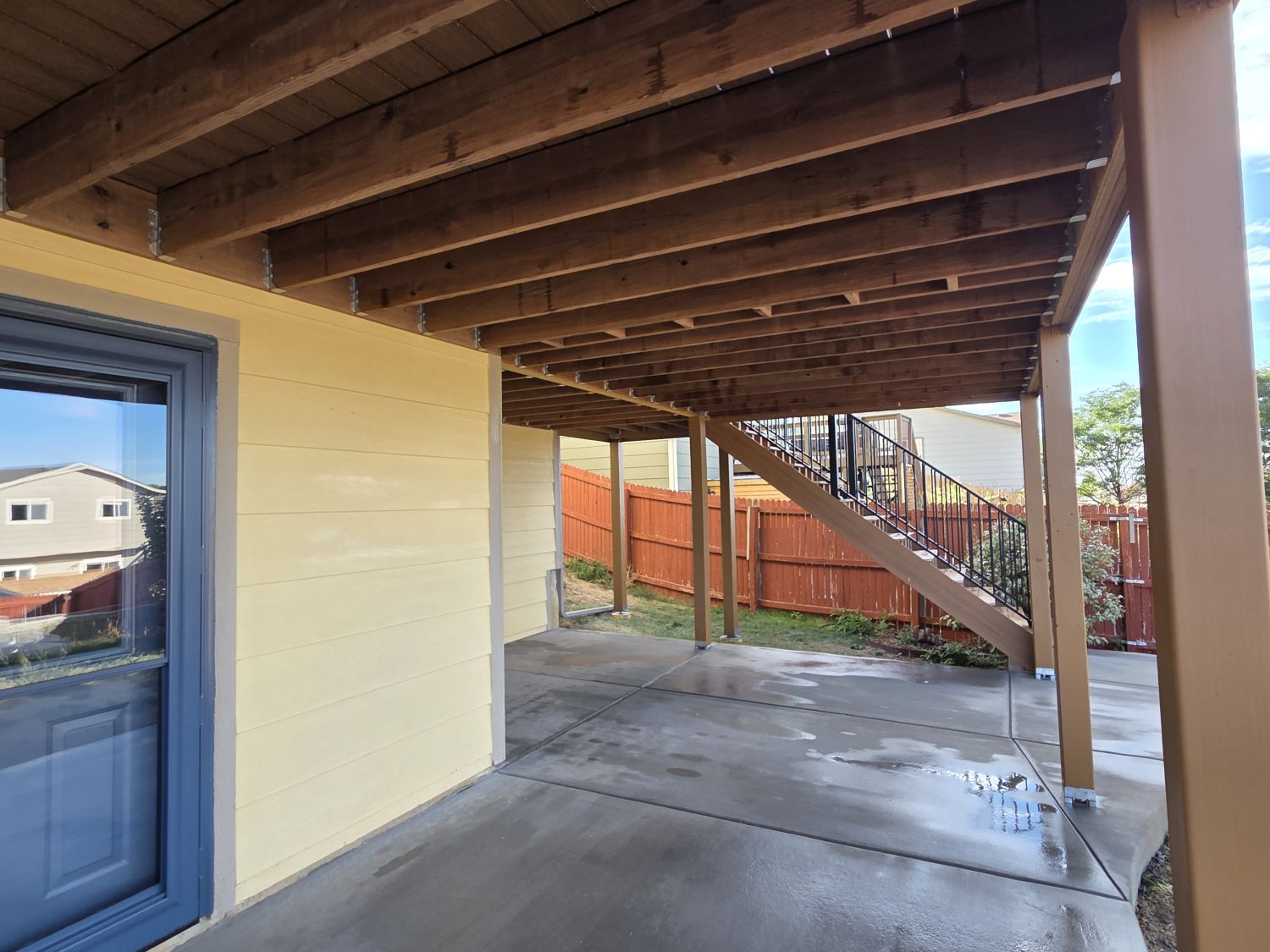 Expanded concrete patio that was poured beneath a new composite deck provides another outdoor living space in Colorado Springs