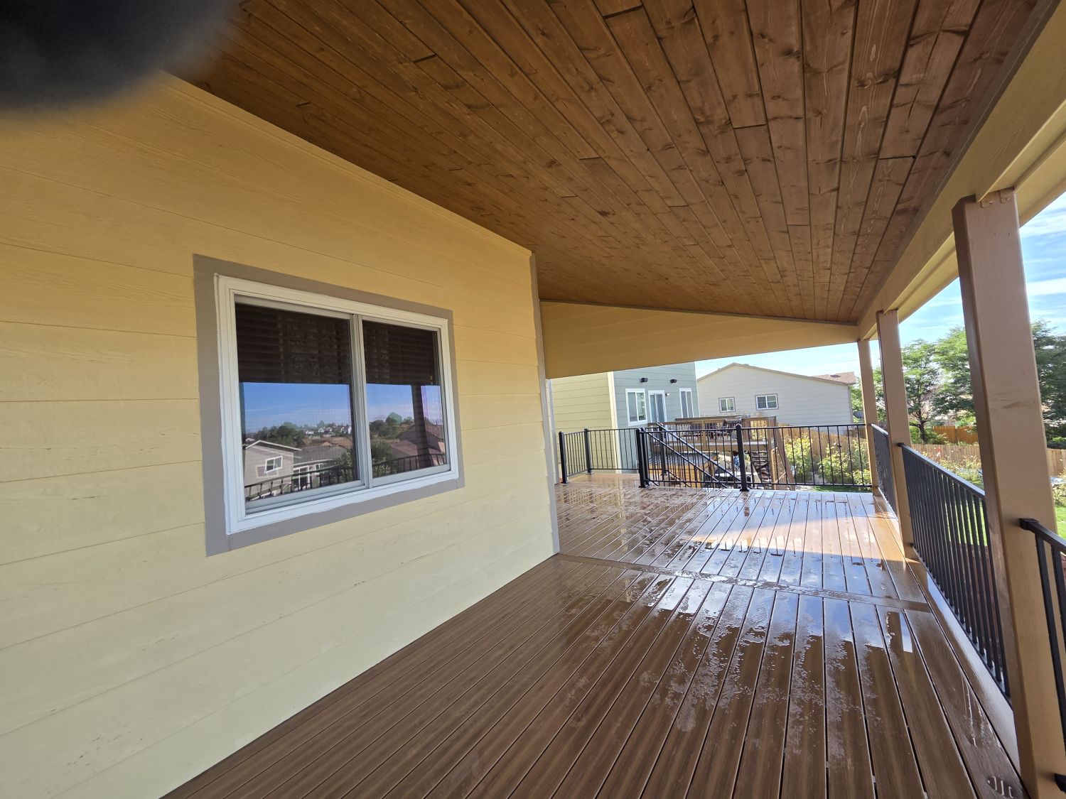 WoodTone Texas Honey Brown tongue-and-groove ceiling beneath the shed-roof deck cover in Colorado Springs